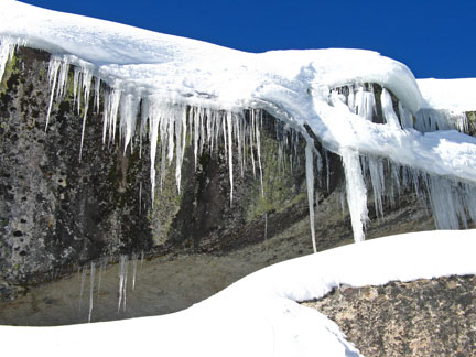 Image of icicles on granite wall.