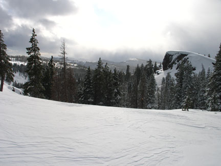 Image of route up to the ridge that ascends the steep section on the camera side of the rock nose in the right of the image
