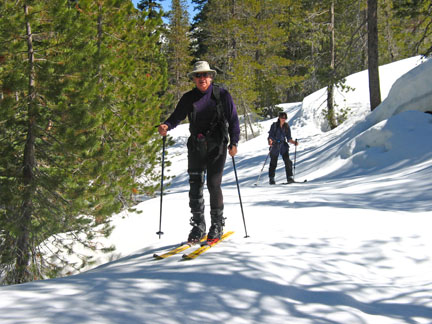 Image of skiers climbing along road