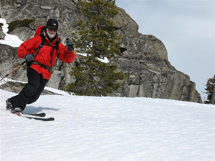 Image of skier descending perfect corn-snow below Peak 7563.
