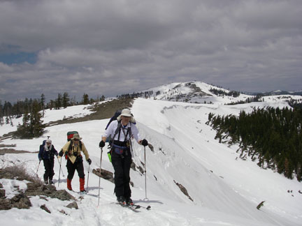 Image of skiers on ridge with Mt. Lincoln in backtground