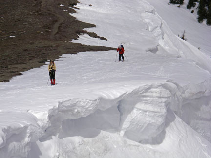 Image of skiers above cornices