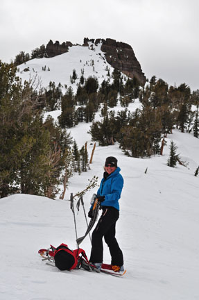 Image of skier shedding climbing skins after reaching ridgetop