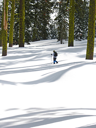 Image of skier climbing toward ridgetop