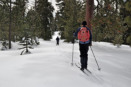Image of skiers on broad ridge